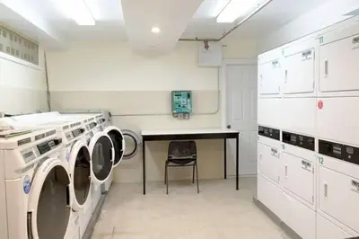 a laundry room with a table and a chair at Urban Luxury Hudson River Suite in New York