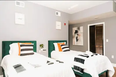 two beds in a room with white and green at The Philly Factory! in Philadelphia