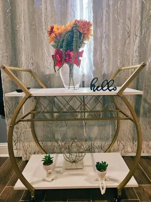a white shelf with a vase with flowers in it at The Philly Factory! in Philadelphia