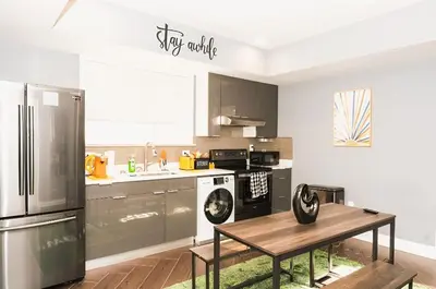 a kitchen with stainless steel appliances and a table at The Philly Factory! in Philadelphia
