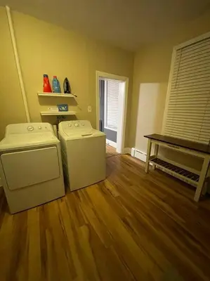 a living room with two machines and a wooden floor at House of the Heart at Trolley Square! in Wilmington