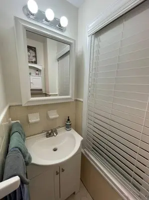 a bathroom with a sink and a mirror at House of the Heart at Trolley Square! in Wilmington
