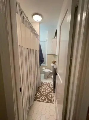 a bathroom with a shower and a toilet in it at House of the Heart at Trolley Square! in Wilmington
