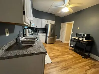 a kitchen with a counter top and a kitchen with a refrigerator at House of the Heart at Trolley Square! in Wilmington