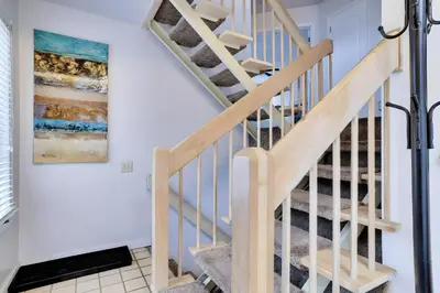 a staircase in a house with a painting on the wall at Lake Harmony Retreat Perfect Family Getaway in Lake Harmony