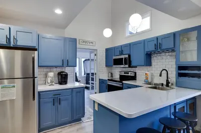 a blue kitchen with stainless steel appliances and blue cabinets at Lake Harmony Retreat Perfect Family Getaway in Lake Harmony