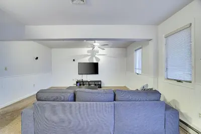 a living room with a blue couch and a tv at Lake Harmony Retreat Perfect Family Getaway in Lake Harmony