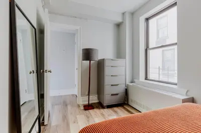a bedroom with a bed and a dresser and a window at Blueground Upper West Side ac wd NYC-1546 in New York