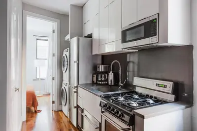 a kitchen with a stove and a microwave at Blueground Gramercy Park 2bd apartment NYC-1616 in New York