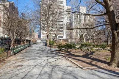 a walkway in a park with trees and buildings at Blueground Gramercy Park 2bd apartment NYC-1616 in New York