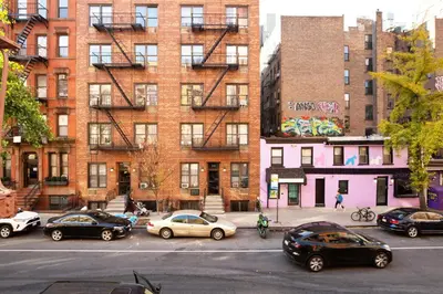 a group of cars parked in front of a building at Blueground Gramercy Park 2bd apartment NYC-1616 in New York