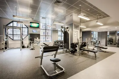 a gym with several treadmills and cardio machines at Blueground Midtown West 1bd apartment NYC-1625 in New York