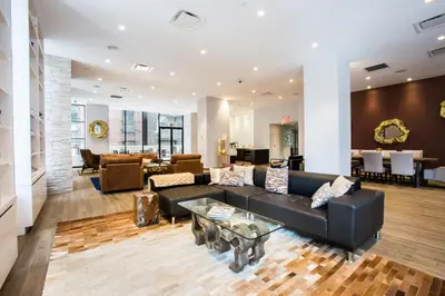 a living room with a black couch and a table at Blueground Midtown West 1bd apartment NYC-1625 in New York