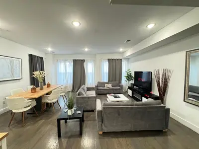 a living room with a couch and a table at Stunning NYC rooftop views minutes away from NYC 2 bedroom 2 bath in Jersey City