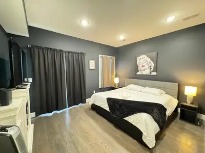 a bedroom with a bed and a flat screen tv at Stunning NYC rooftop views minutes away from NYC 2 bedroom 2 bath in Jersey City