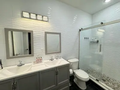 a bathroom with a toilet and a sink and a shower at Stunning NYC rooftop views minutes away from NYC 2 bedroom 2 bath in Jersey City