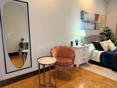 a bedroom with a mirror and a chair and a bed at Bright & New Room Shared Apartment NYC Bus in Englewood