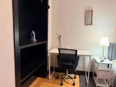 a desk with a chair next to a desk with a lamp at Bright & New Room Shared Apartment NYC Bus in Englewood
