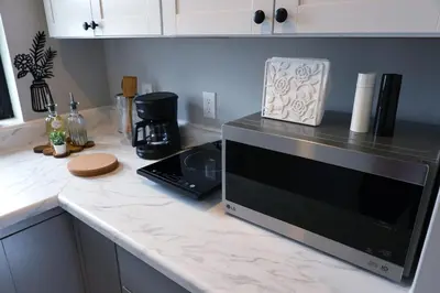 a kitchen counter with a microwave on a counter top at Bright & New Room Shared Apartment NYC Bus in Englewood