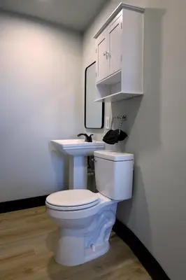 a bathroom with a white toilet and a sink at Bright & New Room Shared Apartment NYC Bus in Englewood