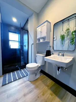 a bathroom with a toilet and a sink and a shower at Bright & New Room Shared Apartment NYC Bus in Englewood