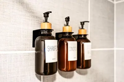 a group of three bottles of soap on a shelf at Spacious 3-Bedroom Apt in the Heart of Philly in Philadelphia