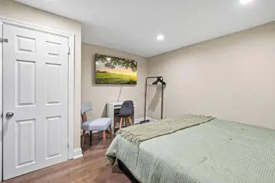 a bedroom with a bed and a desk with a chair at Spacious 3-Bedroom Apt in the Heart of Philly in Philadelphia