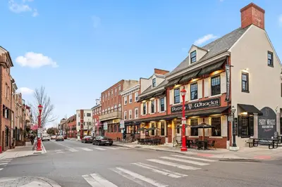 an empty city street with a crosswalk in front of buildings at Spacious 3-Bedroom Apt in the Heart of Philly in Philadelphia