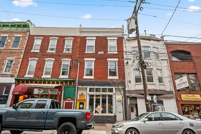 a truck parked on a street in front of buildings at Spacious 3-Bedroom Apt in the Heart of Philly in Philadelphia