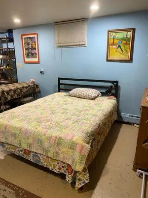 a bedroom with a bed and a blue wall at Cozy charming private studio in North Bergen