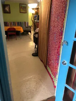 a hallway with a door open to a living room at Cozy charming private studio in North Bergen