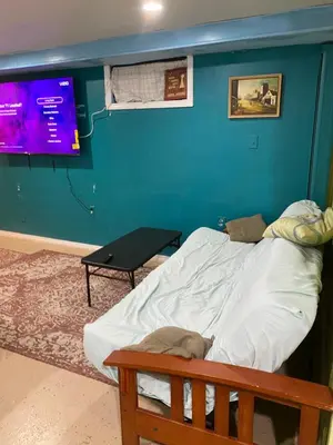 a bedroom with a large bed and a tv at Cozy charming private studio in North Bergen