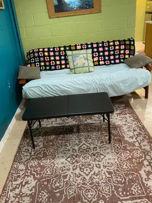 a couch and a table in a room with a rug at Cozy charming private studio in North Bergen