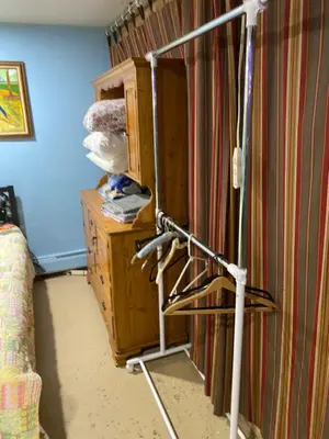 a room with a stand in front of a curtain at Cozy charming private studio in North Bergen