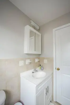 a bathroom with a white sink and a toilet at Newark Liberty Brick House - Private Bedroom 1 in Newark