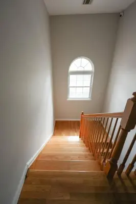 a stairway with a window and a stair case at Newark Liberty Brick House - Private Bedroom 2 in Newark