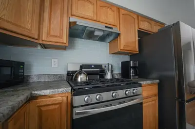 a kitchen with a stove and a refrigerator at Newark Liberty Brick House - Private Bedroom 2 in Newark