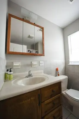 a bathroom with a sink and a mirror and a toilet at Newark Liberty Brick House - Private Bedroom 4 in Newark