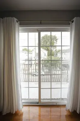 an open window with a view of a patio at Newark Liberty Brick House - Private Bedroom 4 in Newark