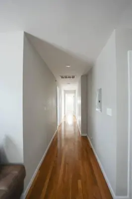 an empty room with a couch and a hallway at Newark Liberty Brick House - Private Bedroom 4 in Newark