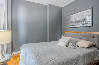 a bedroom with a bed with two pillows on it at Stylish 3Bd in Manhattan near the Empire State Building in New York