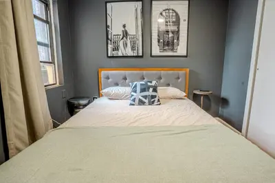 a bedroom with a bed with a pillow on it at Stylish 3Bd in Manhattan near the Empire State Building in New York