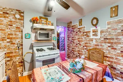 a kitchen with a table and a stove top oven at 15 Mi to NYC Apartment in Newark in Newark