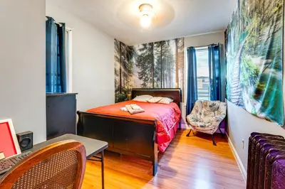 a bedroom with a bed and a desk and a chair at 15 Mi to NYC Apartment in Newark in Newark