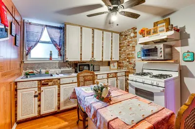 a kitchen with a table and a ceiling fan at 15 Mi to NYC Apartment in Newark in Newark