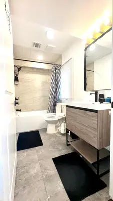 a bathroom with a sink and a tub and a toilet at A Temporary Haven in Newark
