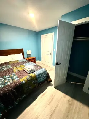 a bedroom with a bed and a white door at A Temporary Haven in Newark