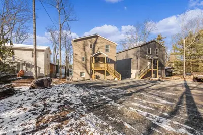 a house with a driveway with snow on the ground at New Luxury Lakeview Retreat with Lake Access, HotTub, Game Room, Sleeps 28 in Lake Harmony