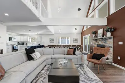 a living room with a couch and a table at New Luxury Lakeview Retreat with Lake Access, HotTub, Game Room, Sleeps 28 in Lake Harmony