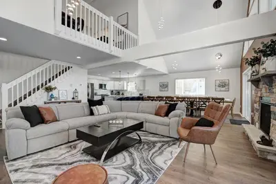 a living room with a couch and a table at New Luxury Lakeview Retreat with Lake Access, HotTub, Game Room, Sleeps 28 in Lake Harmony